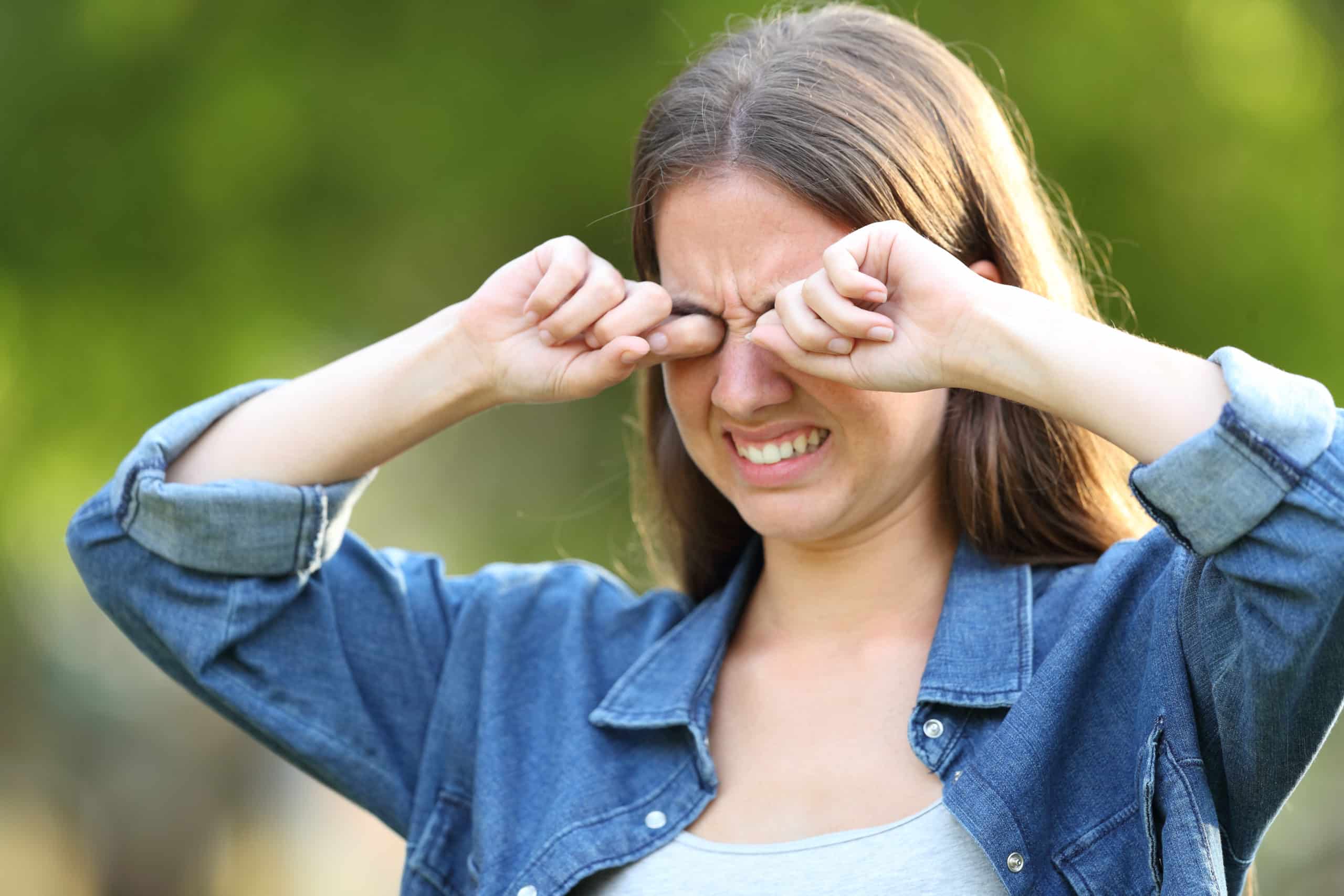 Woman,Suffering,Itching,Scratching,Eyes,Outdoors,In,A,Park,Allergy